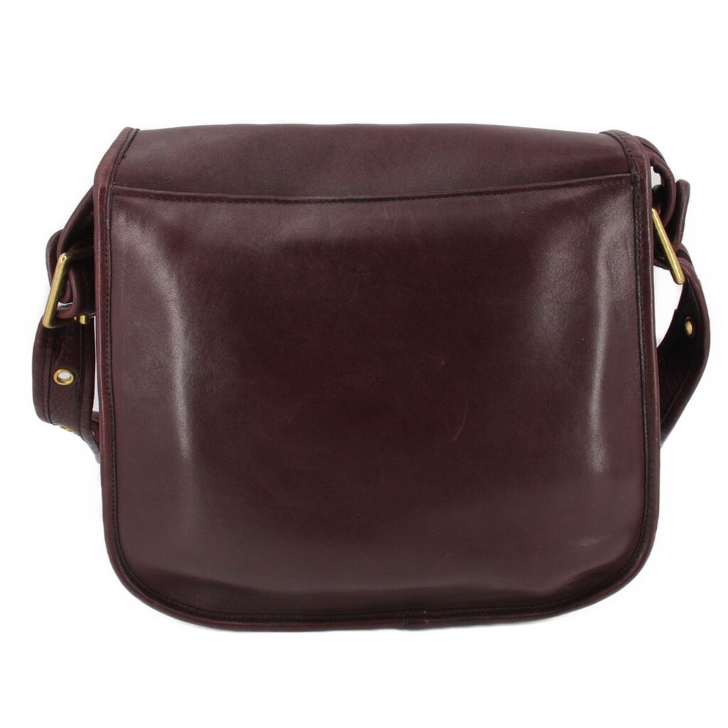 Oxblood leather COACH shoulder bag, back view with curved flap and clean stitching