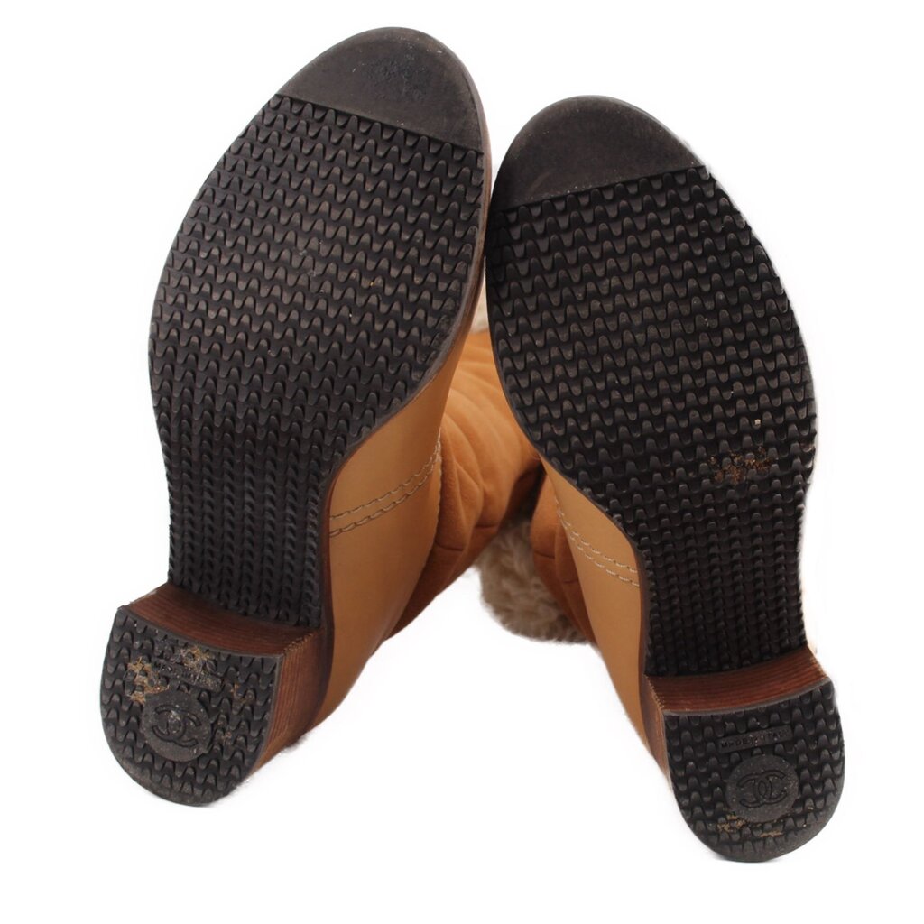Brown suede boot soles and heels with textured tread and Chanel logo embossing