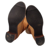Brown suede boot soles and heels with textured tread and Chanel logo embossing