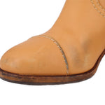 Brown suede boot toe with contrast stitching and textured sole edge