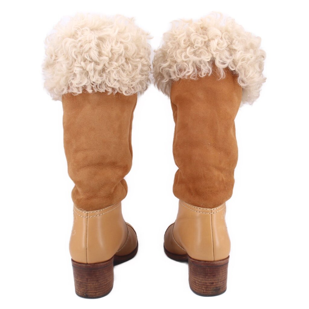 Pair of brown shearling boots with rounded toe and mid block heel