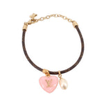Gold monogram bracelet with pink LV heart charm and pearl drop, star toggle clasp