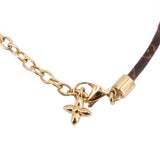 Gold chain bracelet with star charm and clasp, monogram strap end