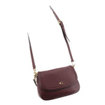 Merlot leather small crossbody bag with curved flap, thin strap, and gold-tone hardware.