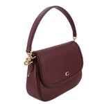 Merlot leather crossbody bag with fold-over flap, single shoulder strap, gold-tone ring hardware.