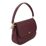 Merlot leather crossbody bag with fold-over flap, single shoulder strap, gold-tone ring hardware.