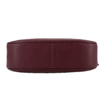 Merlot leather crossbody bag bottom view with stitched base seam and rounded shape.