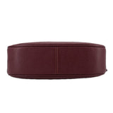 Merlot leather crossbody bag bottom view with stitched base seam and rounded shape.