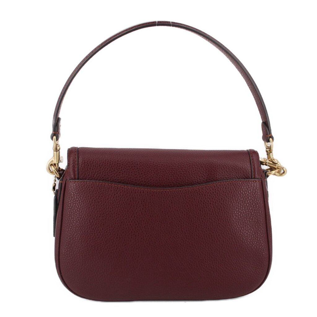 Merlot leather crossbody bag front view with top handle strap, flap pocket detail, gold accents.