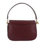 Merlot leather crossbody bag front view with top handle strap, flap pocket detail, gold accents.