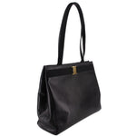 Black leather vintage shoulder bag with structured sides and top handle
