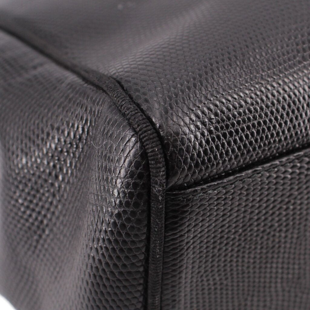 Close-up of black textured leather panel with stitched corner seam