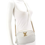 White quilted crossbody camera bag with gold-tone LV logo and chain strap