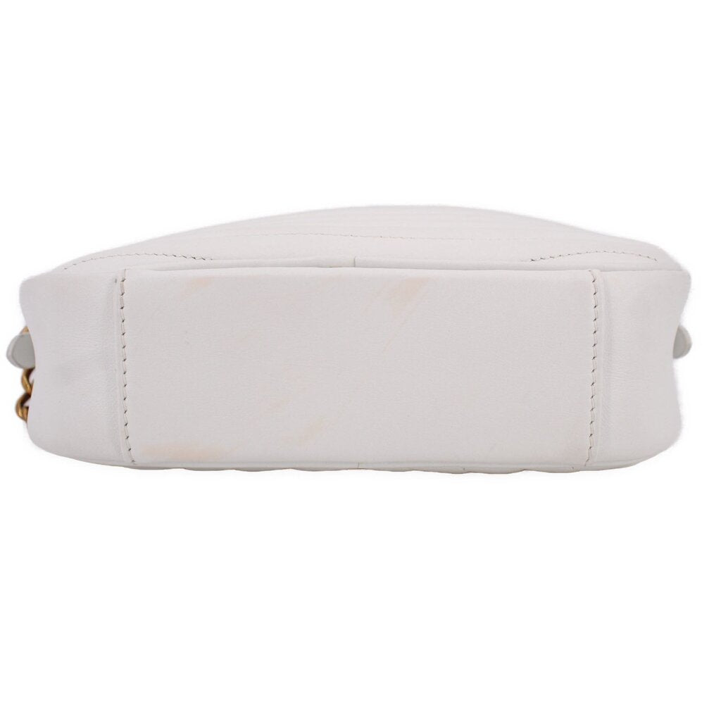 White camera crossbody bag, bottom view with stitched base and chain strap hardware