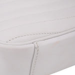 Close-up of white bag panel with stitched trim and curved seam detail
