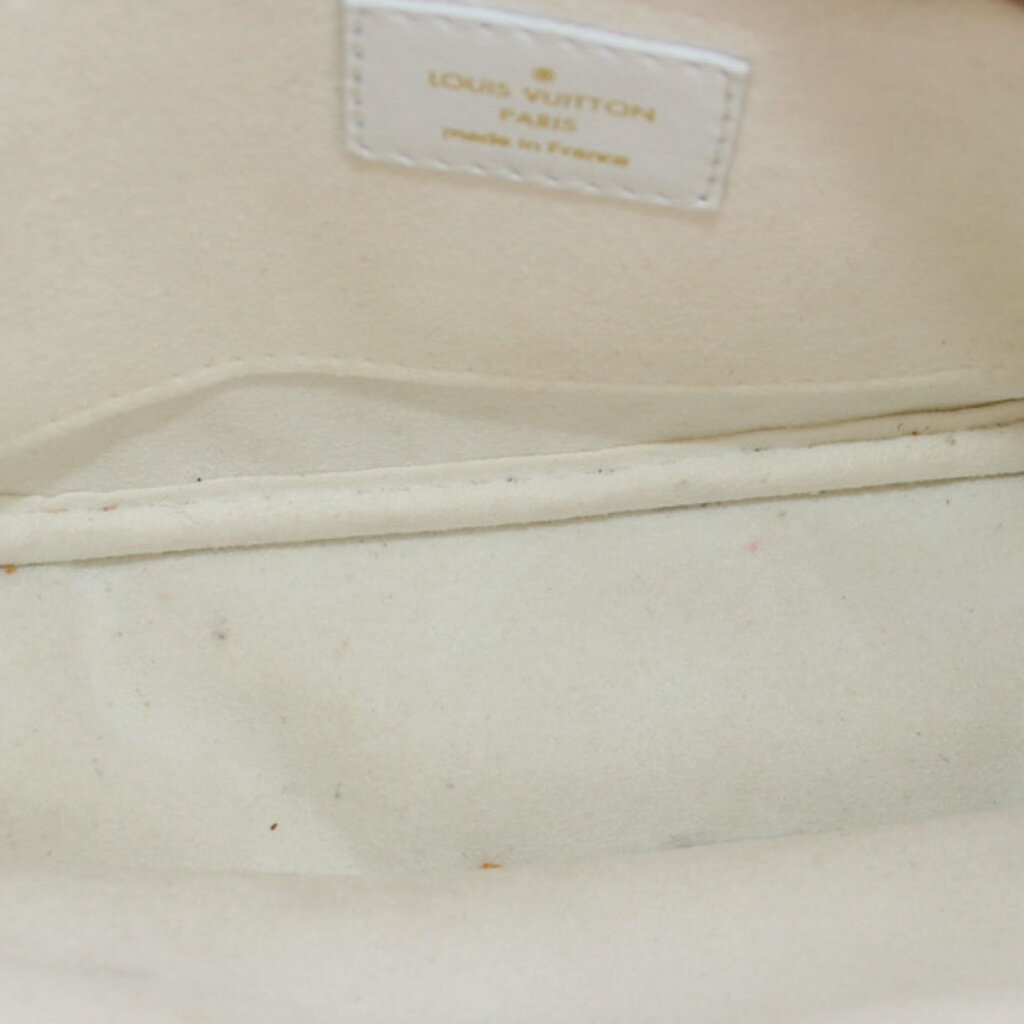 Close-up of white interior fabric with LOUIS VUITTON Paris branding label