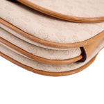 Close-up of GUCCI crossbody bag piping and layered cream canvas with tan trim