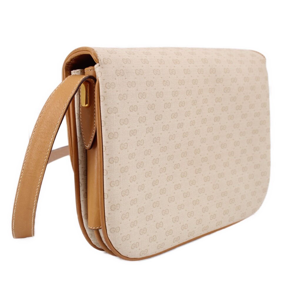 GUCCI vintage crossbody bag side profile with tan strap and curved flap edge