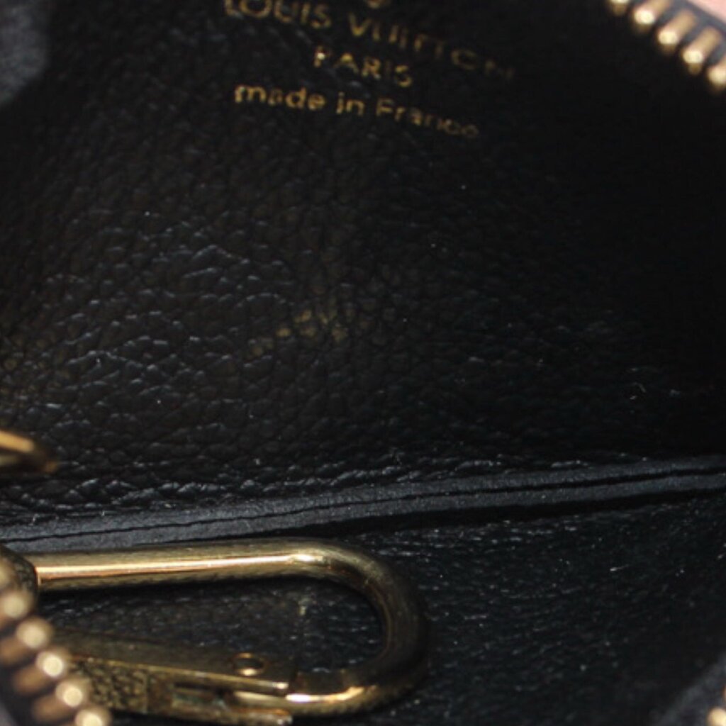 Close-up of black Empreinte leather and gold zipper hardware, made in France