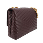 Brown quilted leather shoulder bag with gold chain strap, side profile