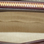 Beige woven interior lining with gold zipper trim at top edge