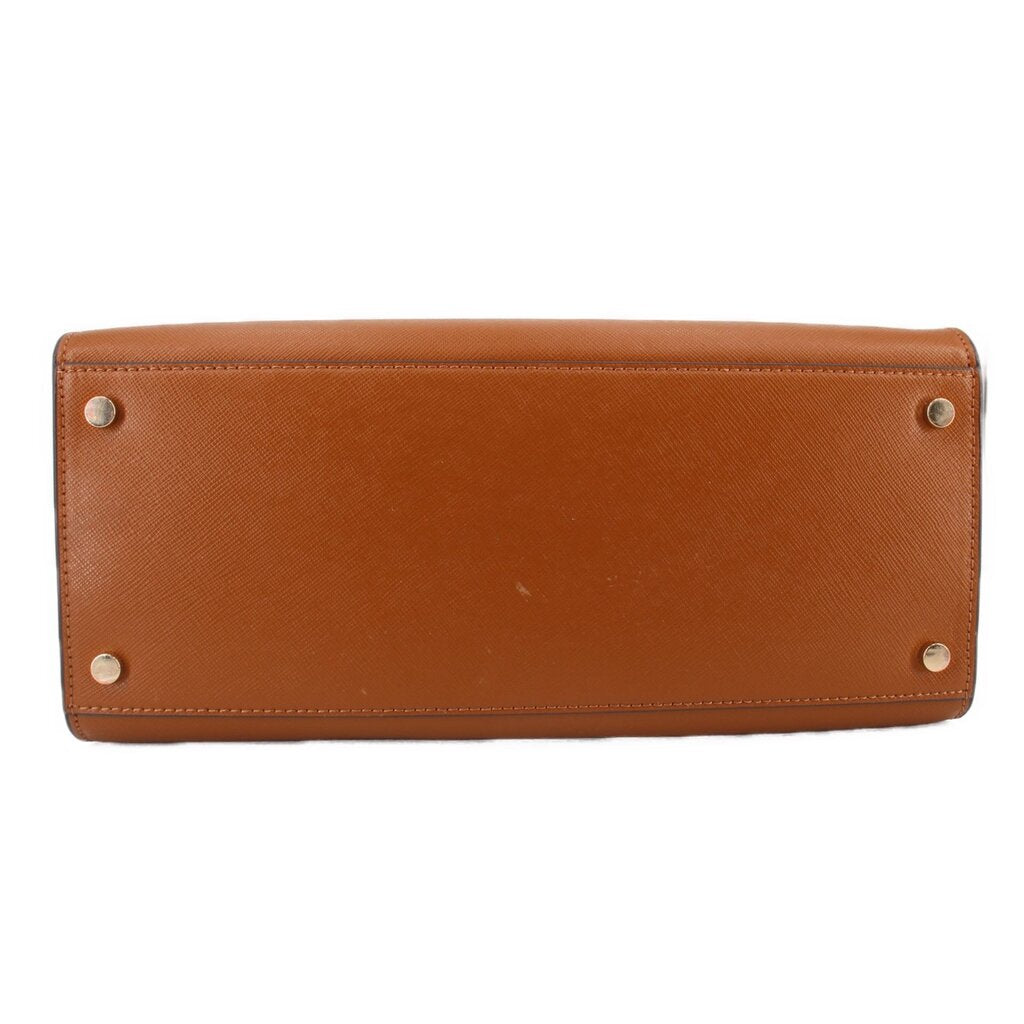 Brown leather satchel bottom panel with four metal feet