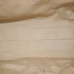 Gold raffia tote bag weave texture close-up with soft fabric lining