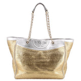 Gold raffia tote bag with silver top panel and chain handles