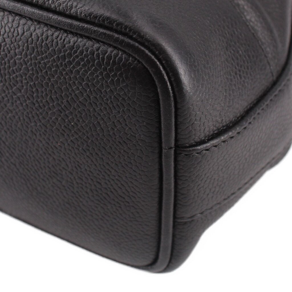 CHANEL black leather bucket crossbody bag close-up of rounded side edge and texture