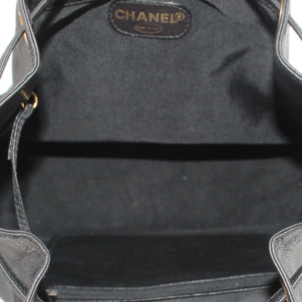 CHANEL black bucket crossbody bag interior with CHANEL label and drawstring opening
