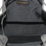 CHANEL black bucket crossbody bag interior with CHANEL label and drawstring opening