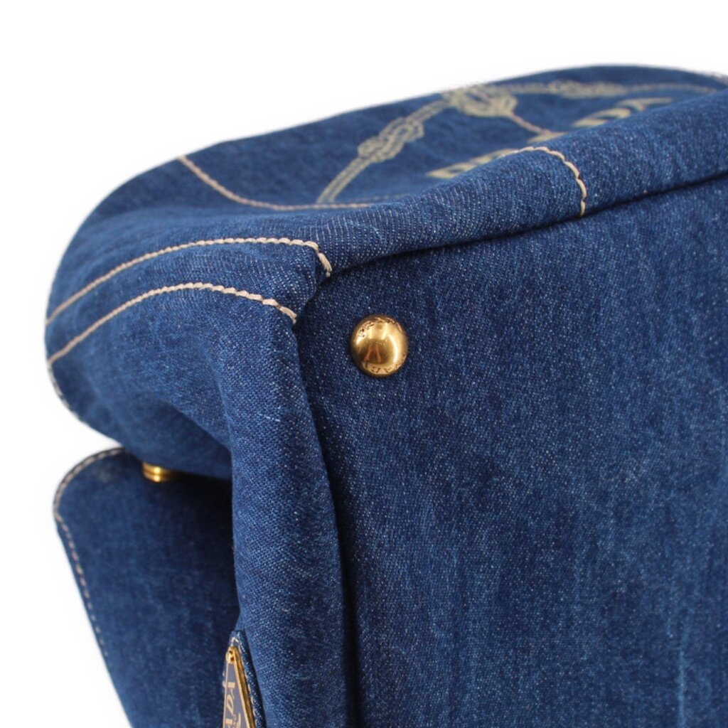 Prada Canapa denim tote bag top corner with gold button and stitched trim