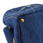 Prada Canapa denim tote bag top corner with gold button and stitched trim