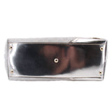 Silver tote bag front panel with gold-tone grommet snaps and textured leather edges