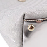 Silver GG-pattern tote bag corner with gold-tone snap and metal hardware