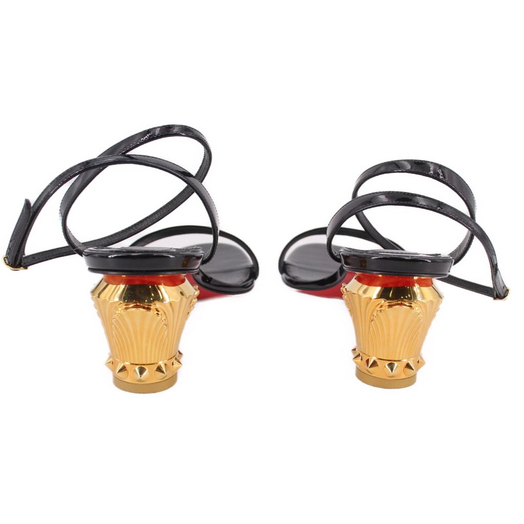 Black patent heeled sandals showing back view with ribbed gold heel