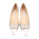 Pair of glitter cap-toe pumps, silver with pointed metallic toe and beige lining