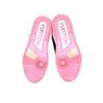 Pink outsoles with traction tread on white and black sneakers