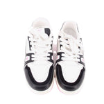 Pair of white and black lace-up sneakers with pink-tinted sole, front view