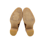 Leopard calf hair boot outsoles with tan tread at heel and toe