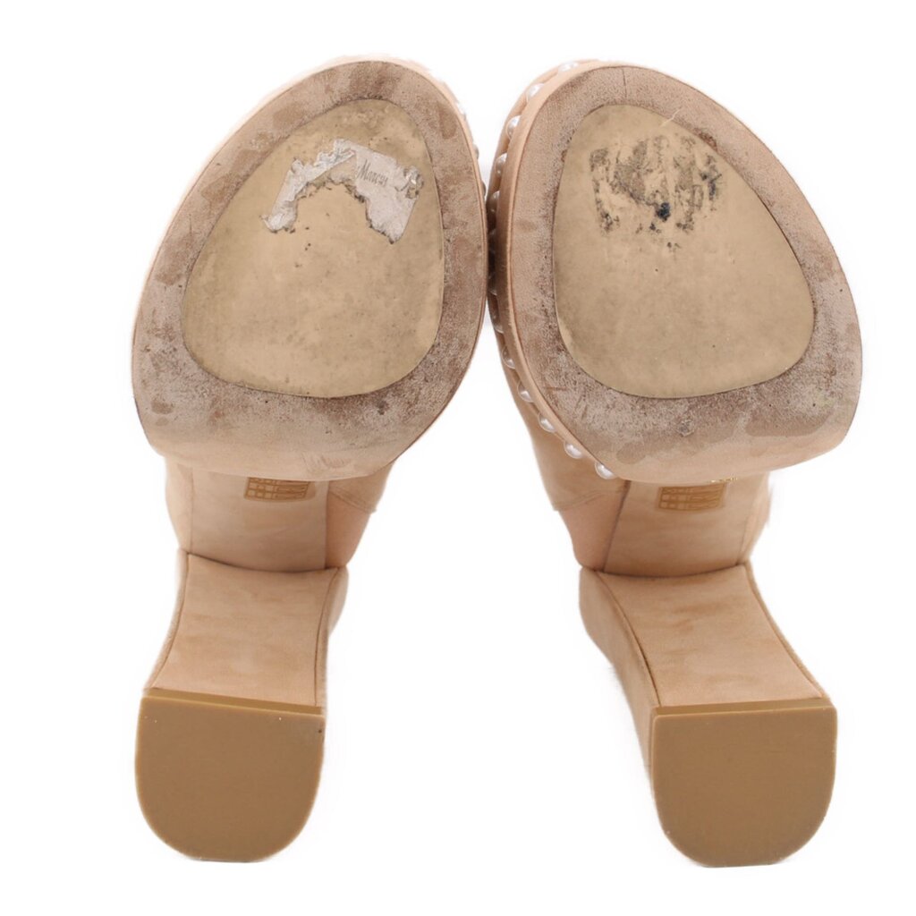 Nude suede platform heels showing rubber outsoles and toe openings