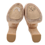 Nude suede platform heels showing rubber outsoles and toe openings