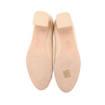 Nude heel soles with brand markings and textured tread on underside