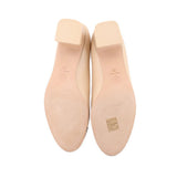 Nude heel soles with brand markings and textured tread on underside