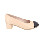 Nude low block-heel pumps with glossy black cap toe and quilted lining
