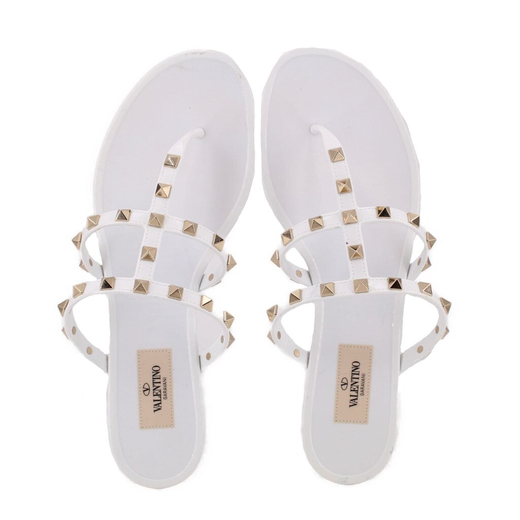 White Valentino rubber Rockstud sandals with gold studs across crossed straps, front view