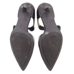 Black kitten heel outsole view with pointed toe and textured heel base