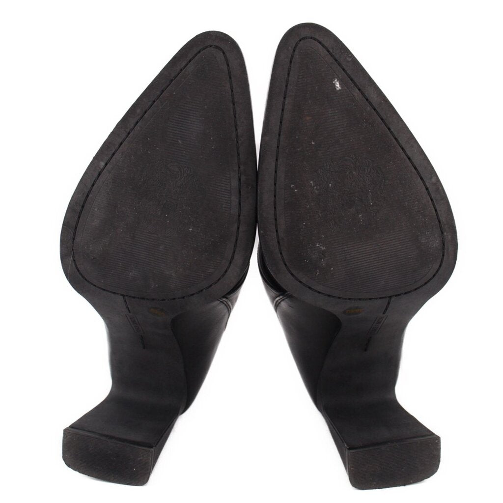 Pair of black ankle booties, heel and back view with textured lining