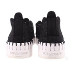 Black slip-on flats with perforated sides and ILSE JACOBSEN HORNBAEK heel branding