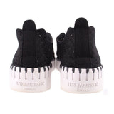 Black slip-on flats with perforated sides and ILSE JACOBSEN HORNBAEK heel branding